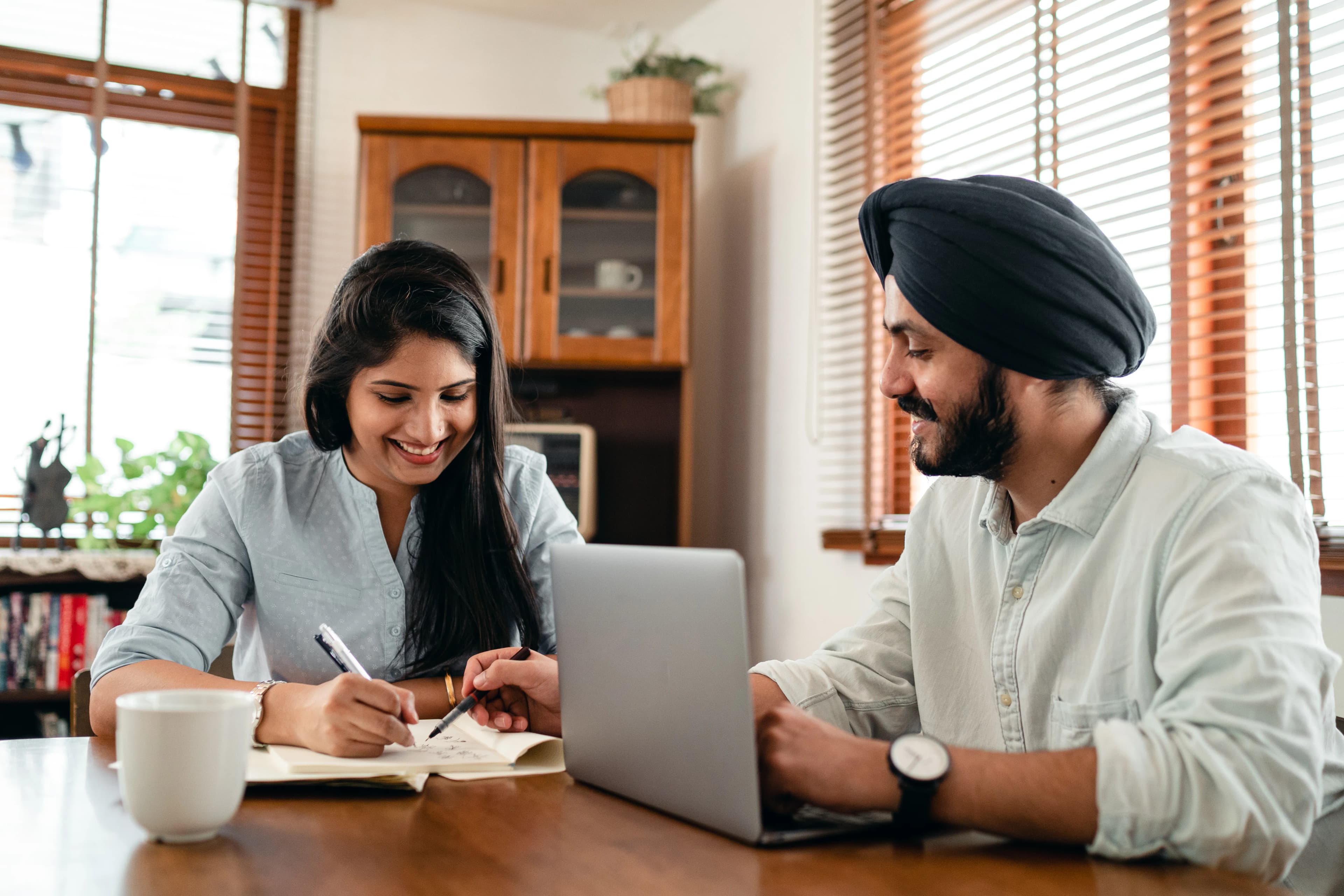 Two partners discussing written plans together at home