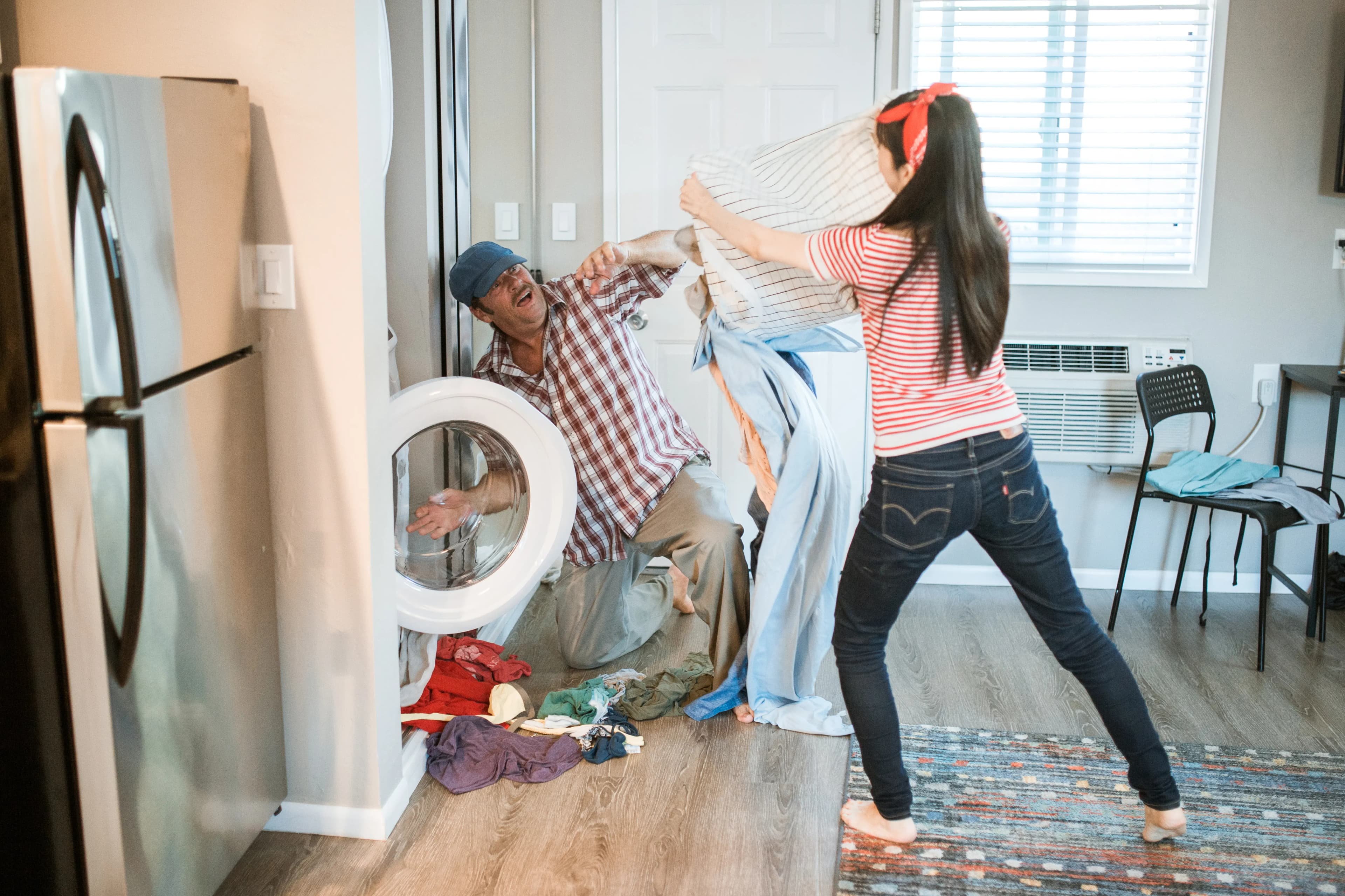 Couple sharing a household laundry task together