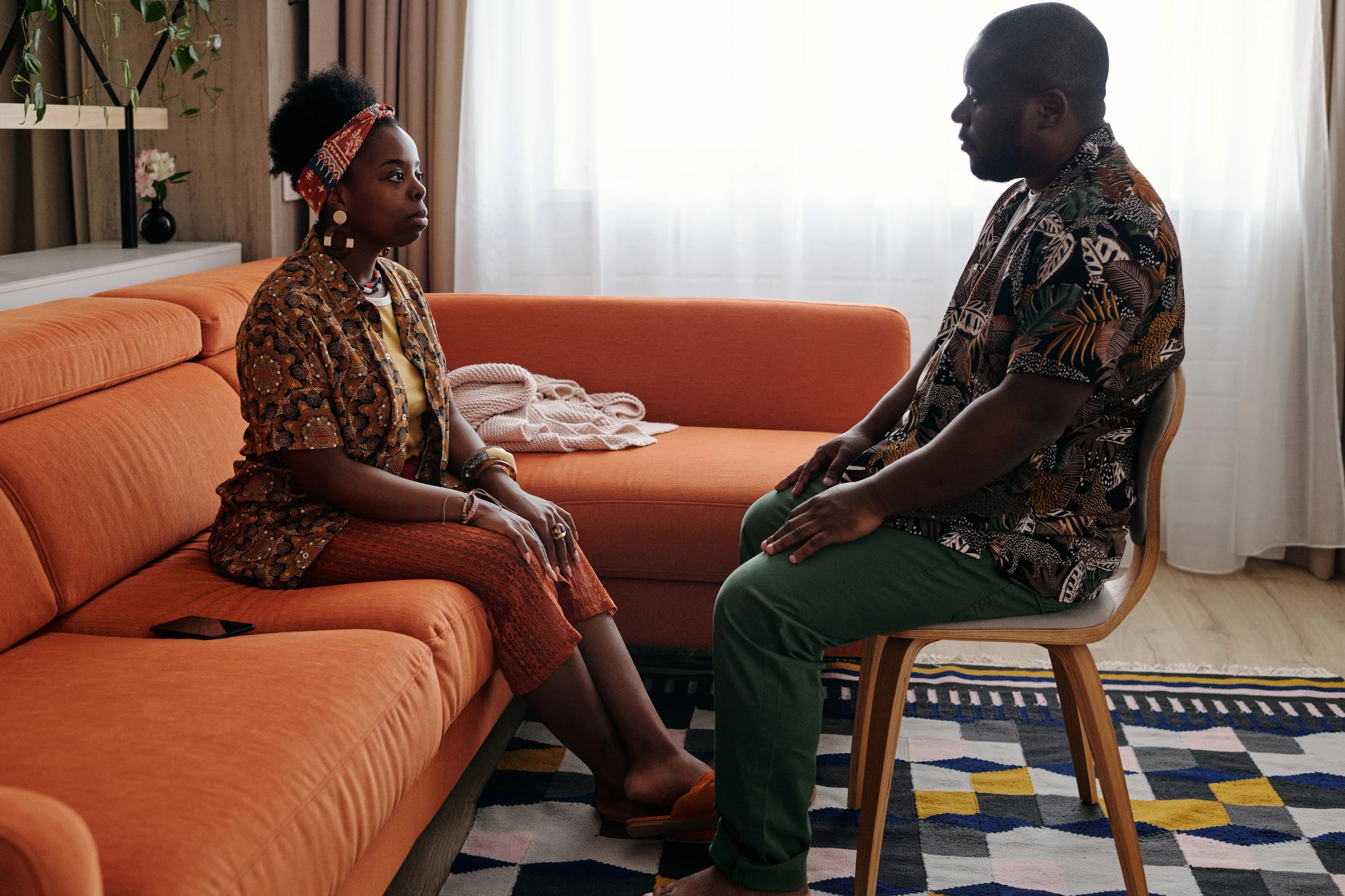 Two partners discussing a relationship topic in their living room