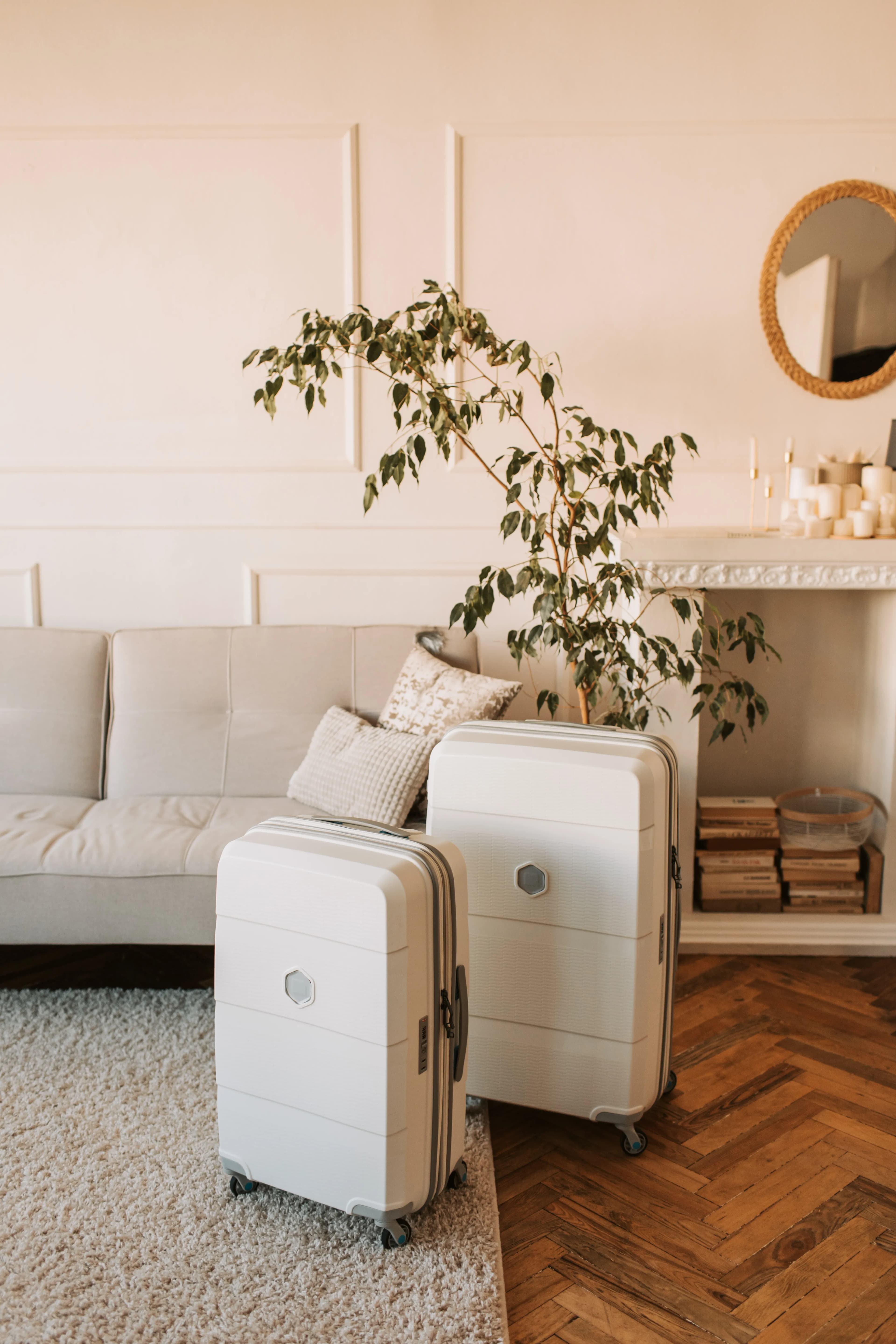 A packed suitcase standing beside a sofa in a quiet home
