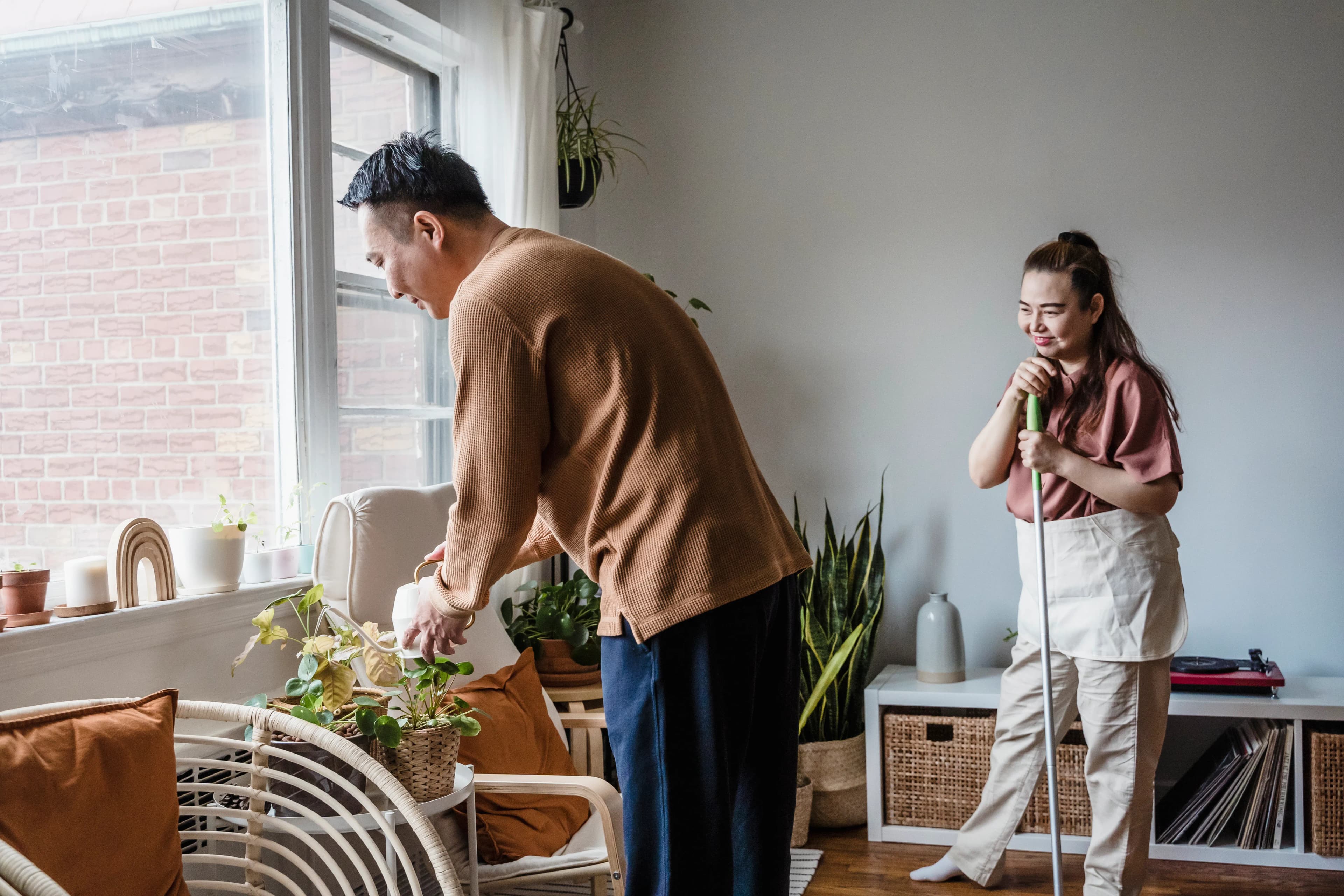 Two partners tending plants and sharing domestic responsibilities