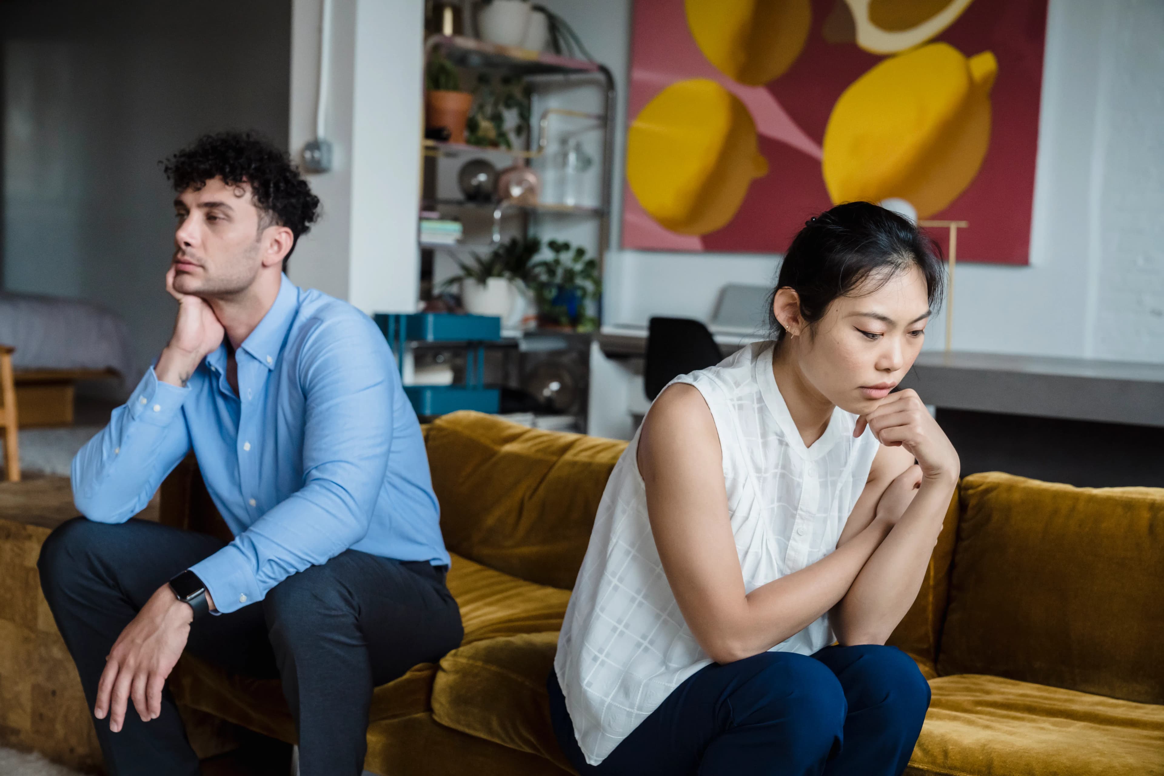 Couple contemplating separately in a shared living room