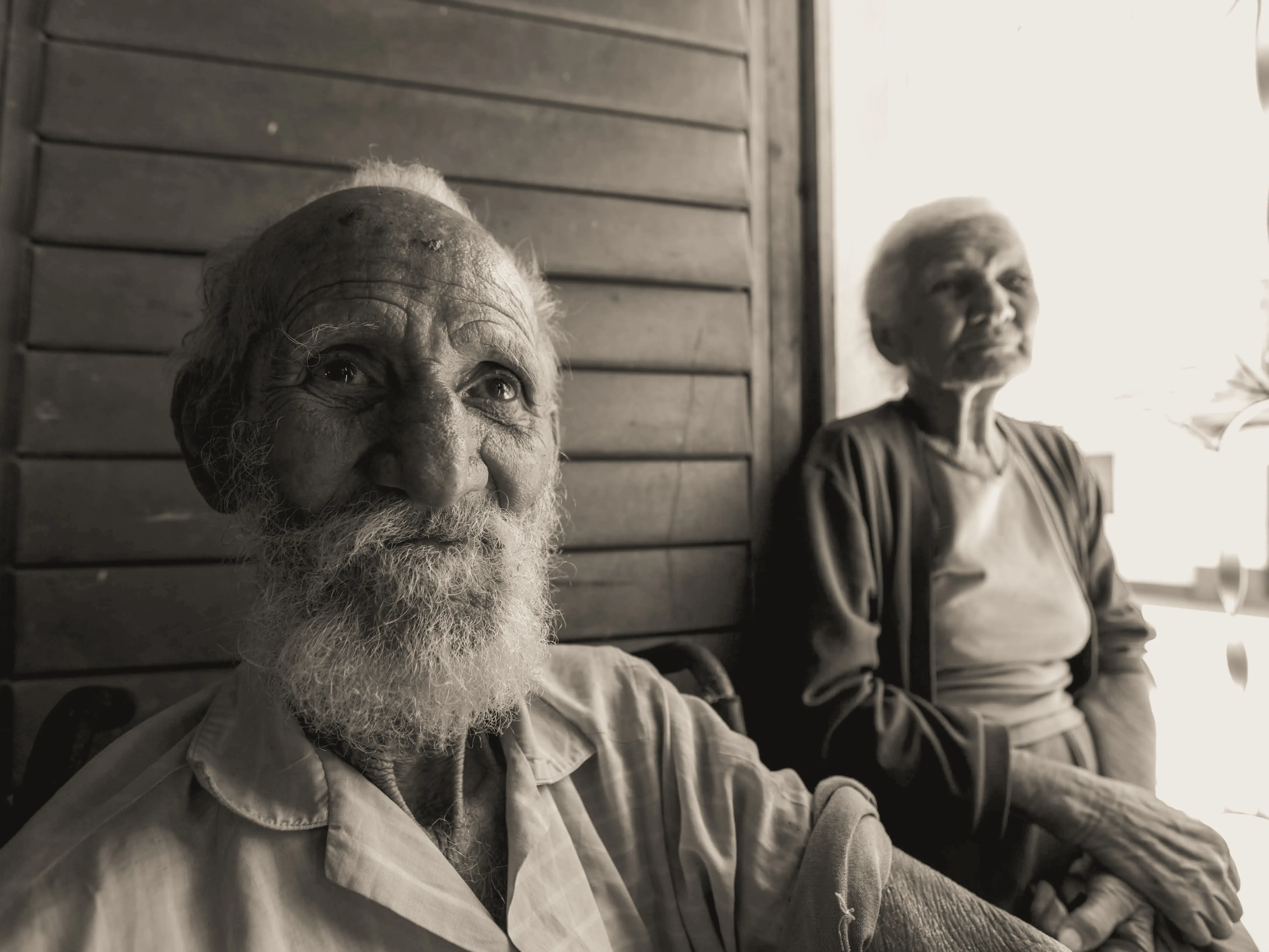 Older couple sitting together in a shared moment of companionship