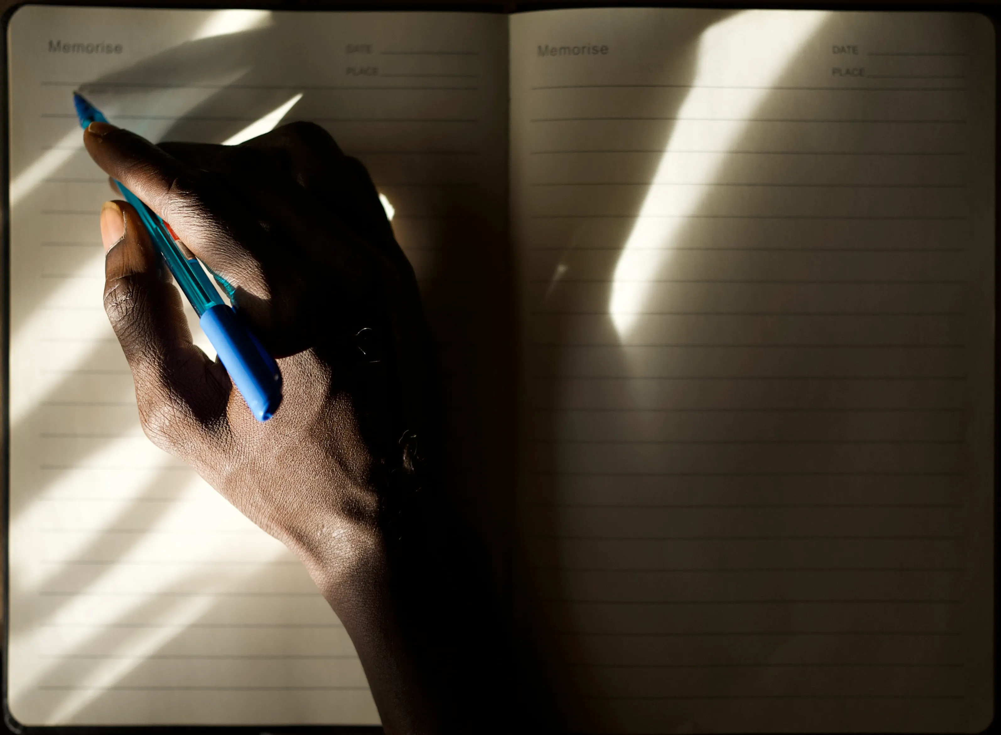 Handwriting in an open journal in warm morning sunlight