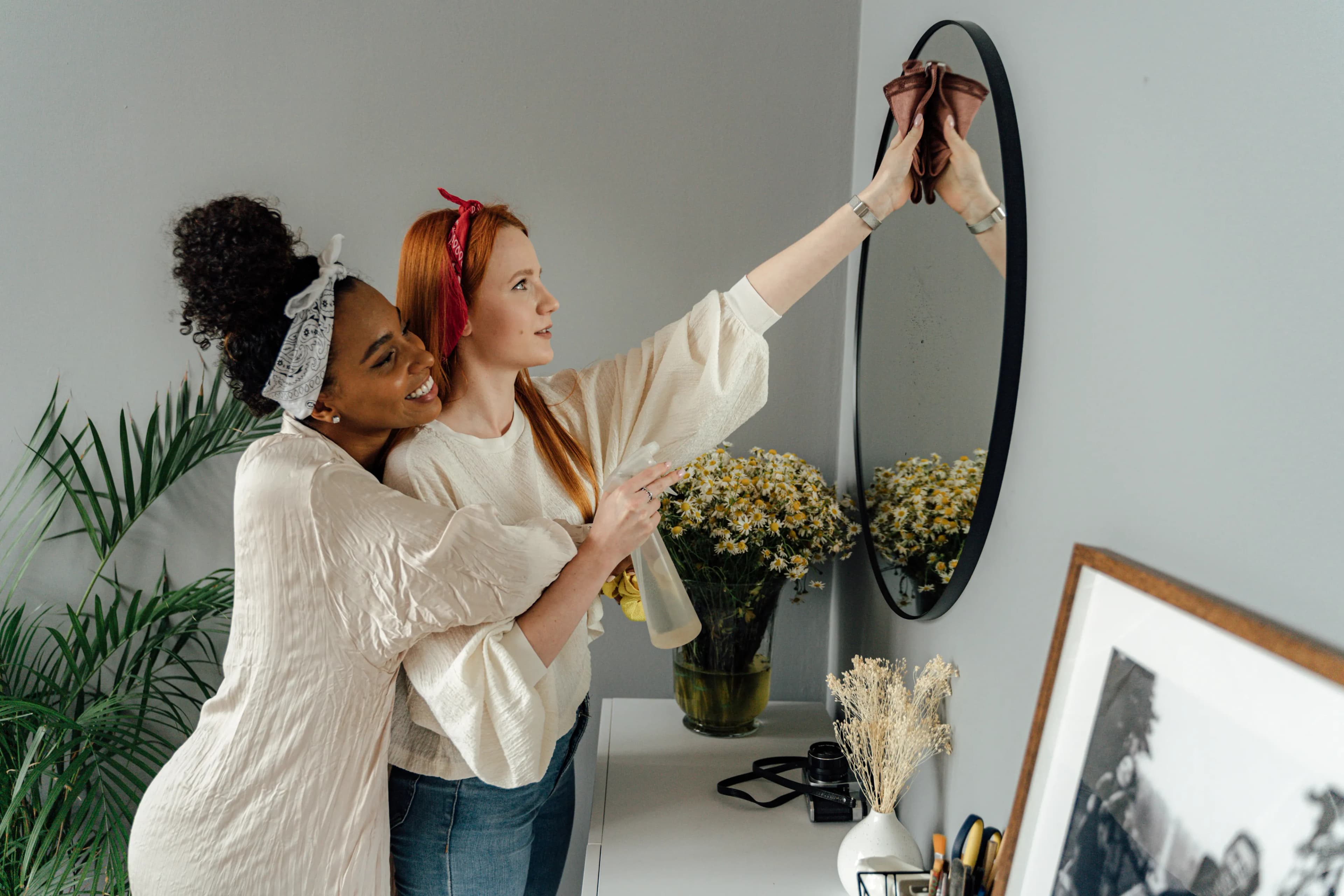 Partners playfully sharing housework in a bright home