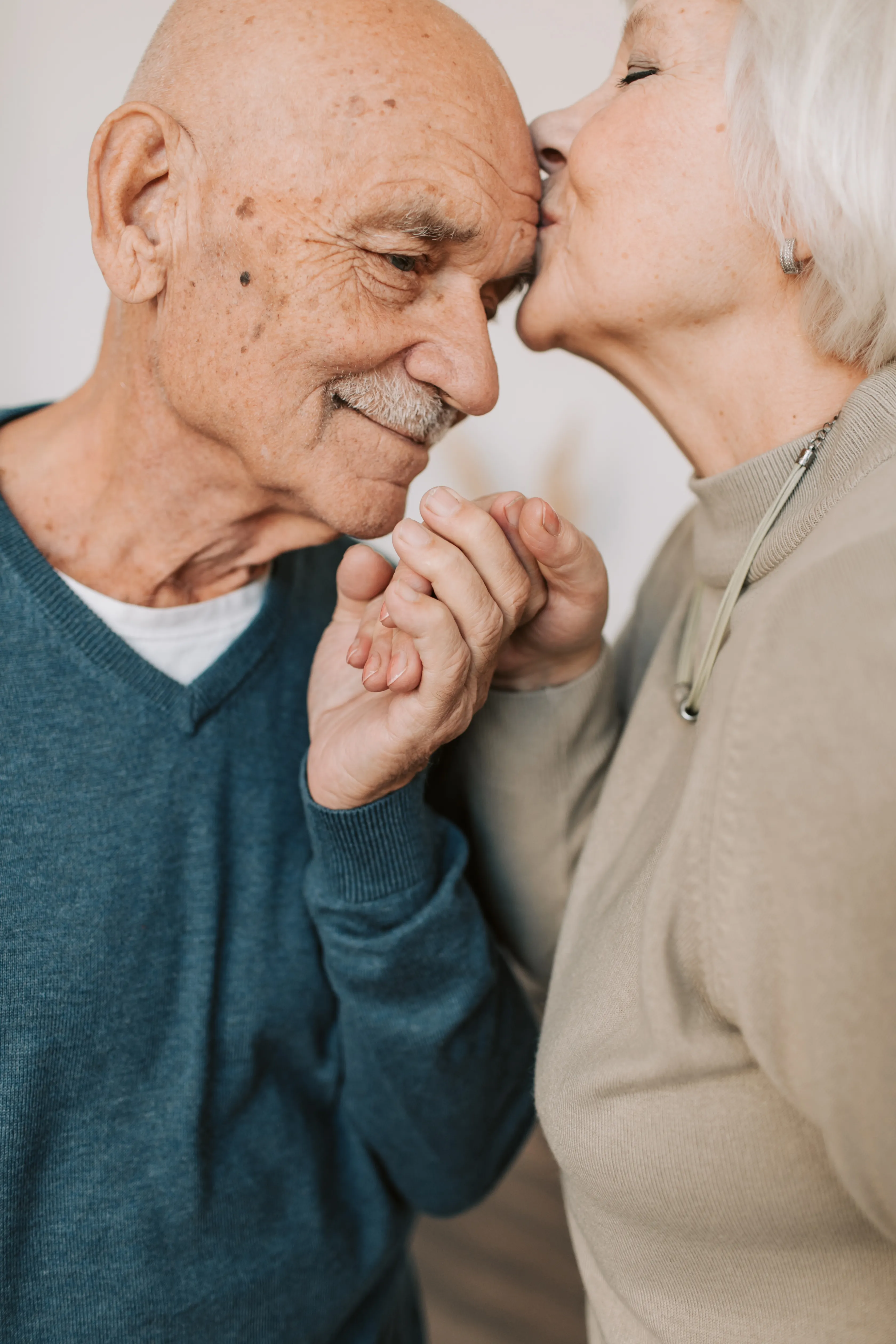 Older couple holding hands and sharing a gentle moment