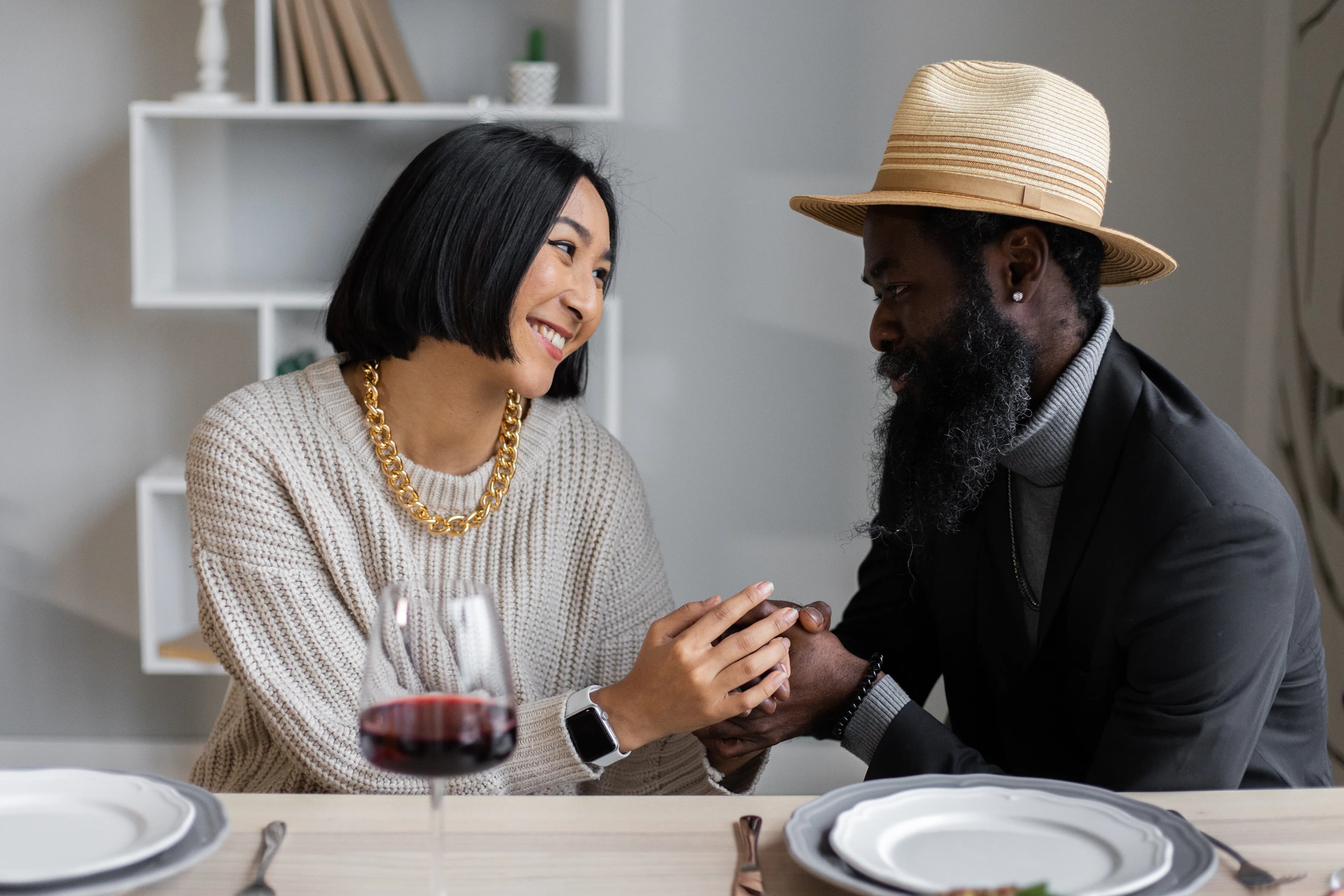 Multiethnic couple speaking together at a dinner table