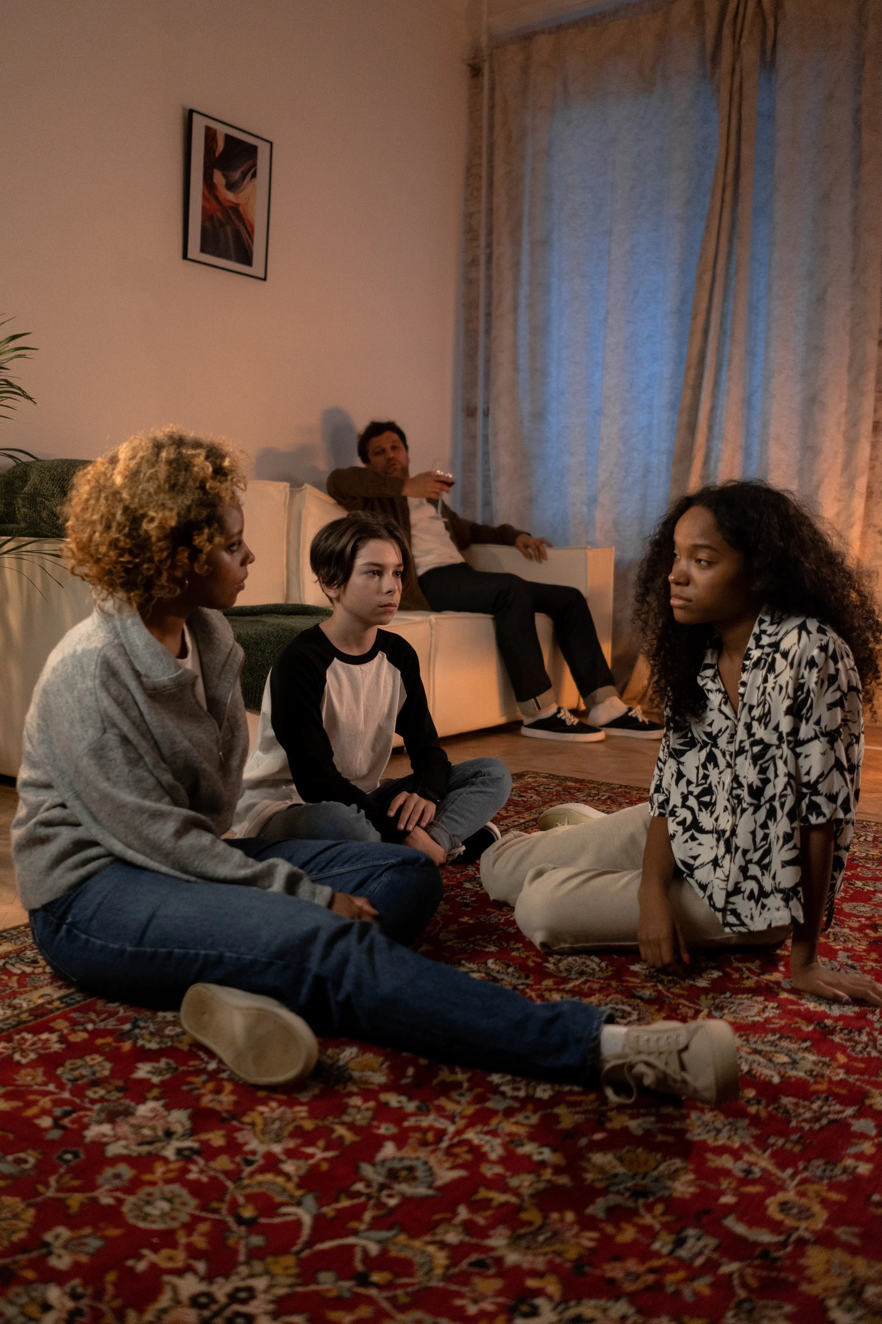 Family members talking together in a warmly lit living room