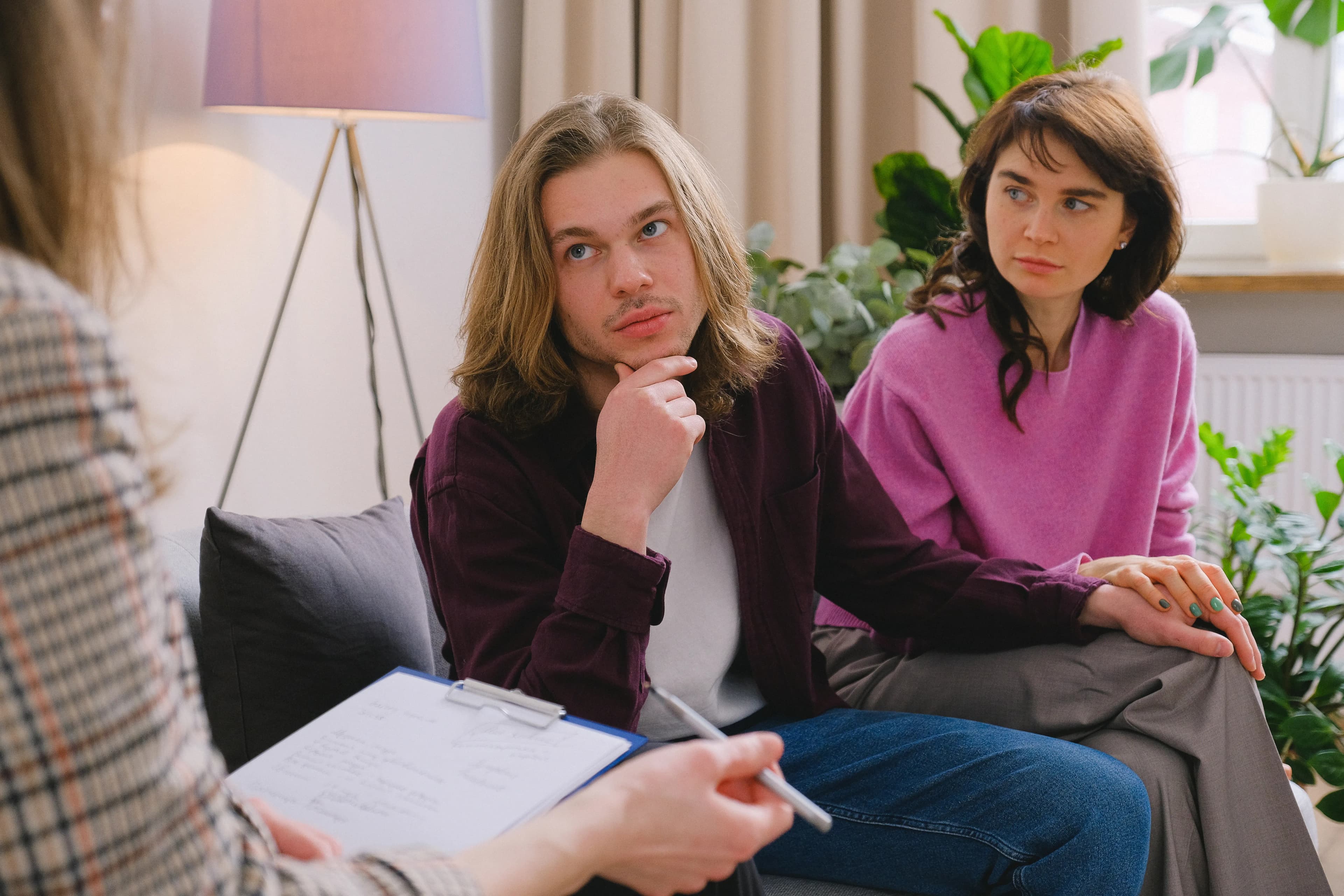 Couple joining hands during a counselling conversation