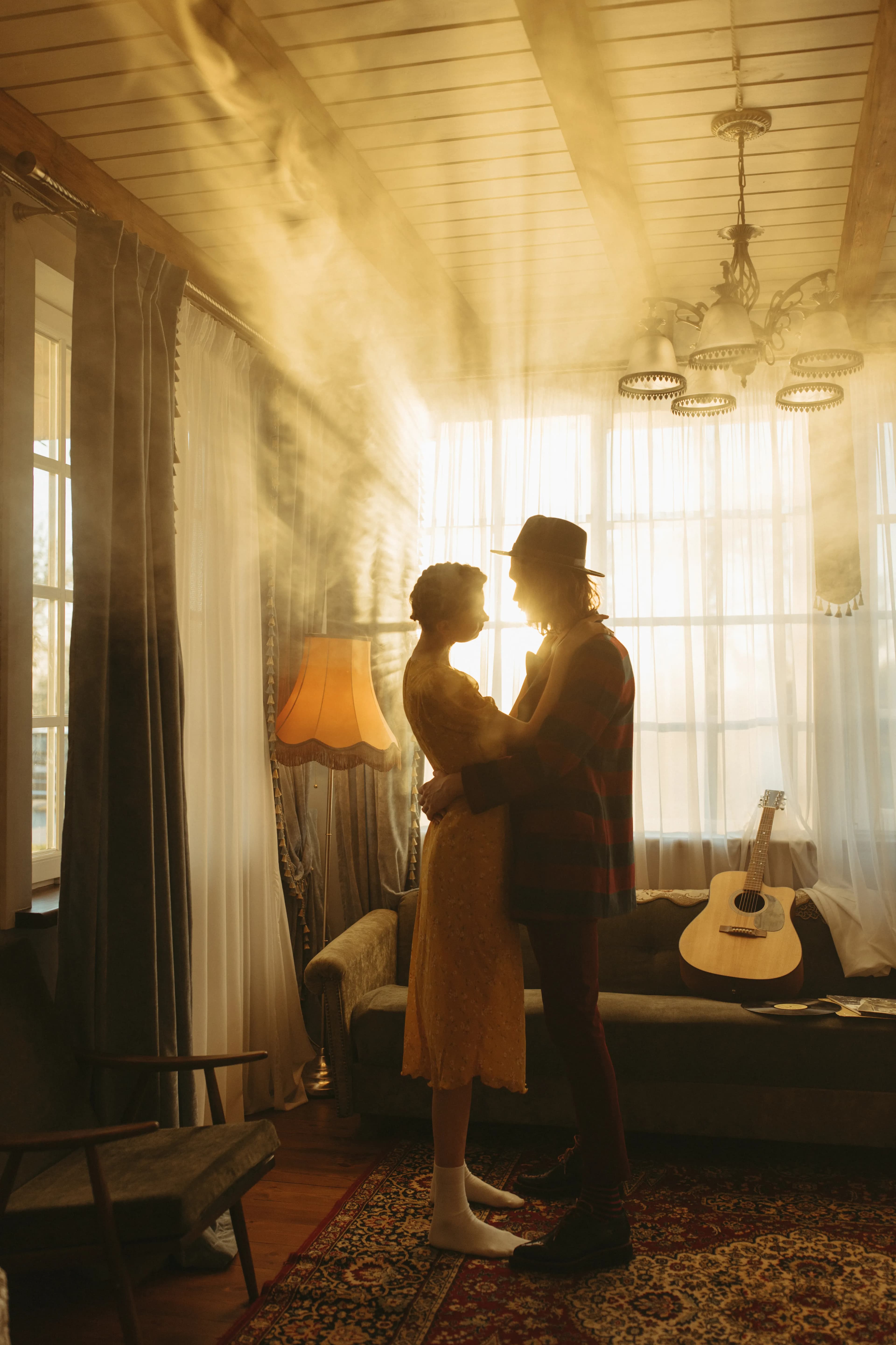 Couple dancing together in a warm and softly lit living room