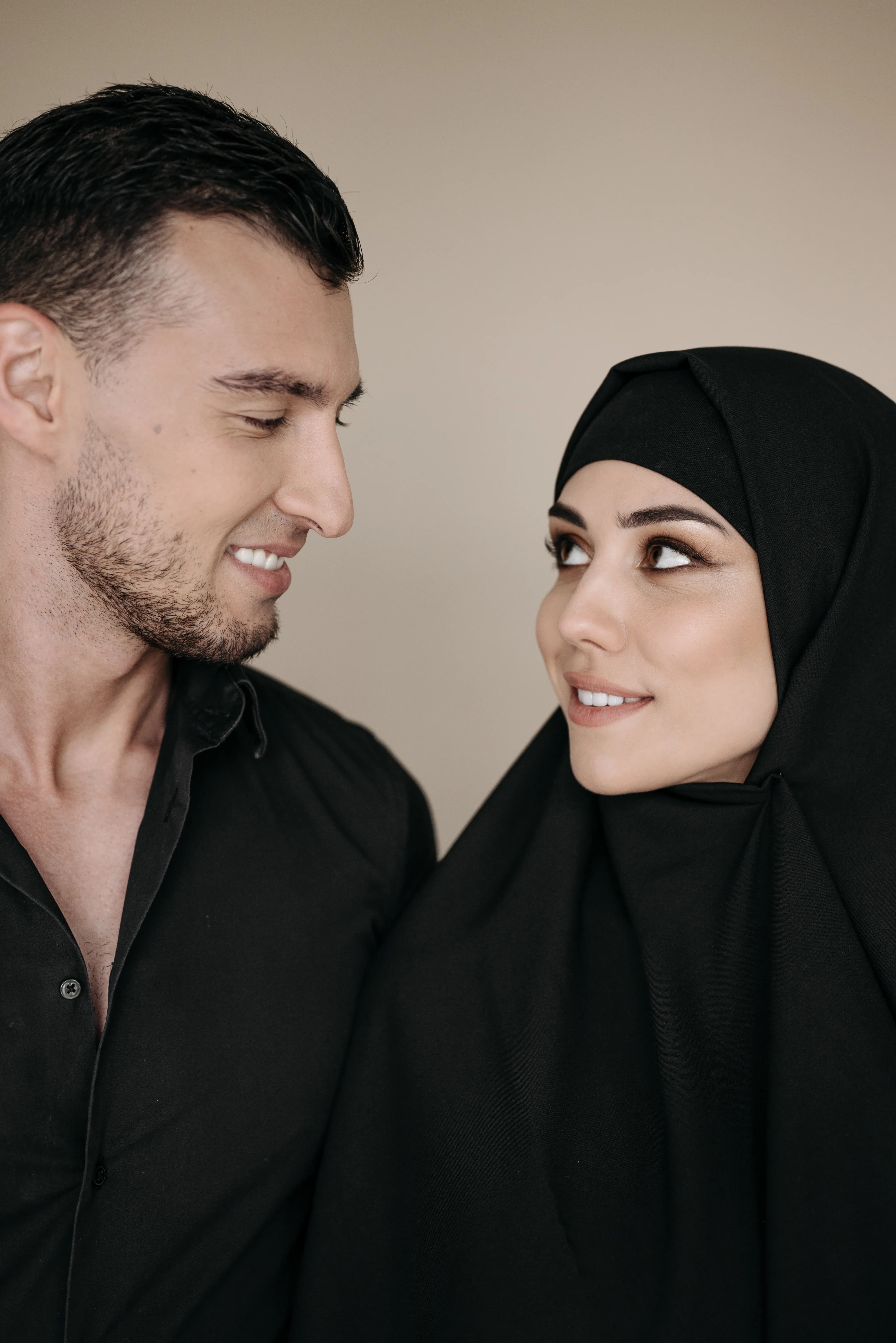 Couple in modest traditional attire looking warmly at one another