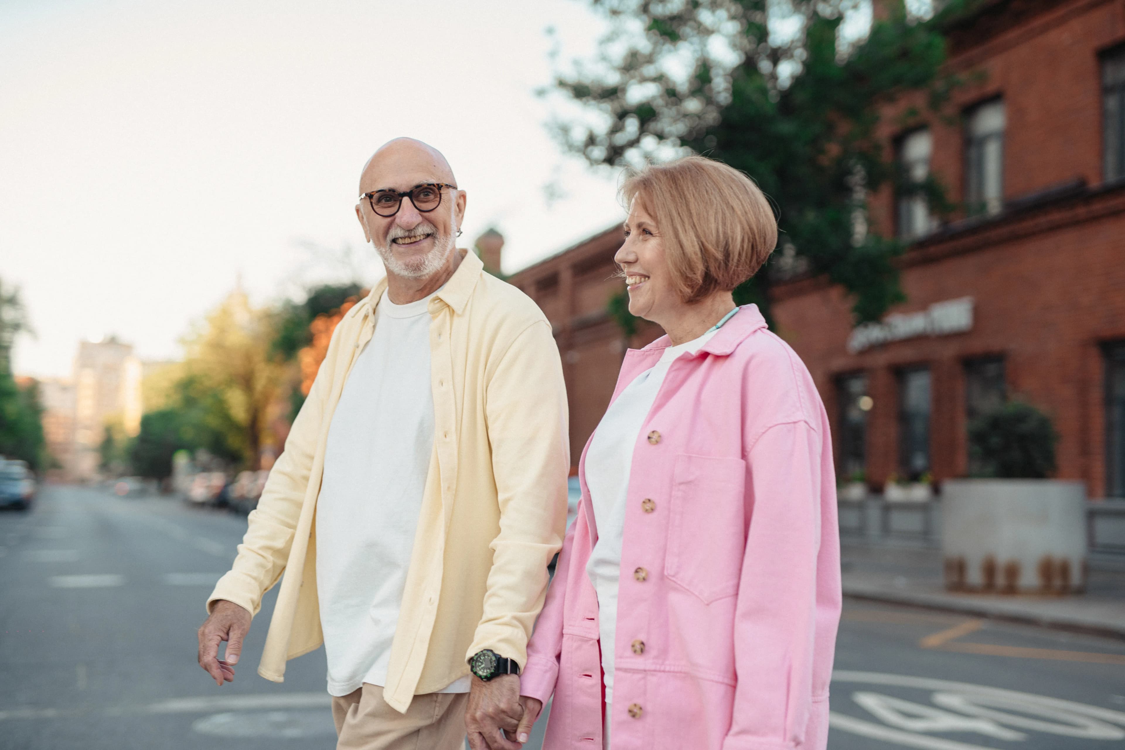 Senior couple holding hands during a walk through the city